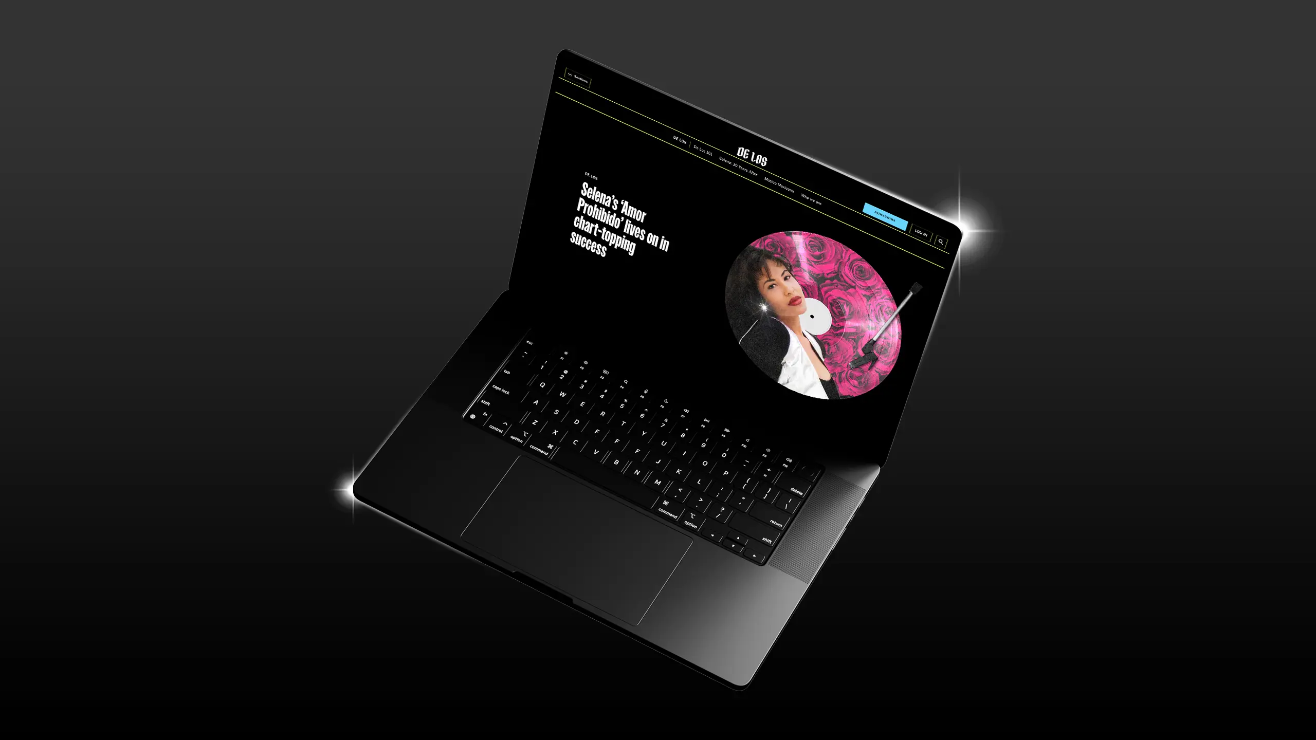 A laptop is shown viewing a De Los article